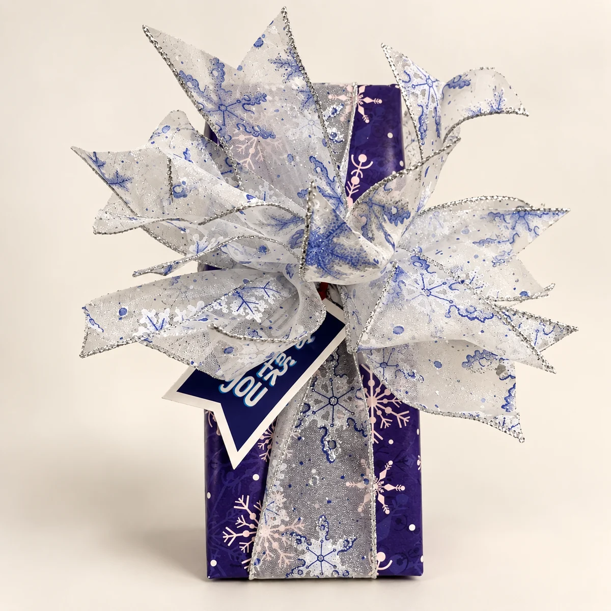 Purple snowflake paper with a silver-edged organza bow